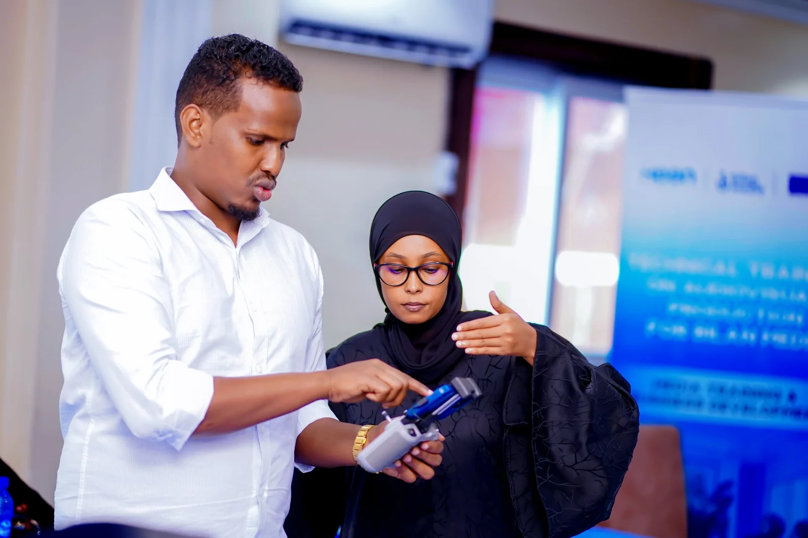 A trainer showing a participant the drone controller during the drone safety session.