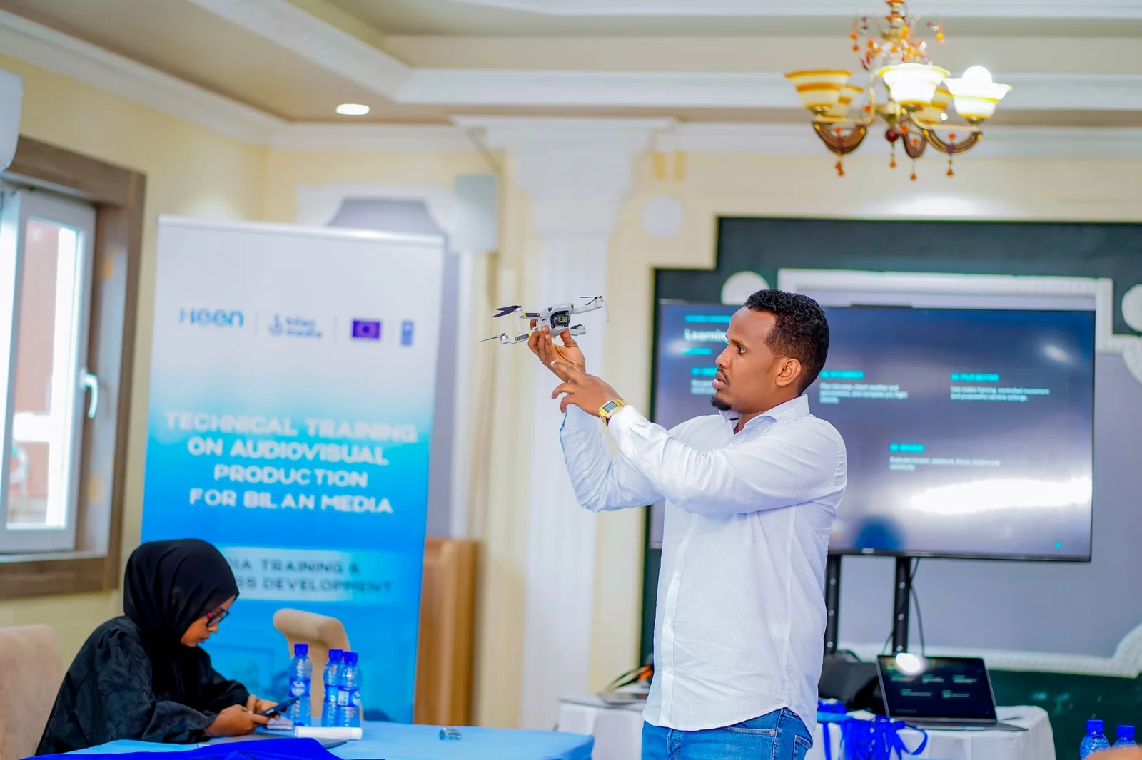 A trainer holding a drone during the drone safety session of the audiovisual production training.