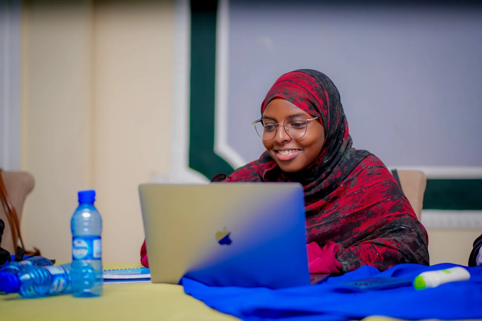 A participant editing video on a laptop during the audiovisual production training.