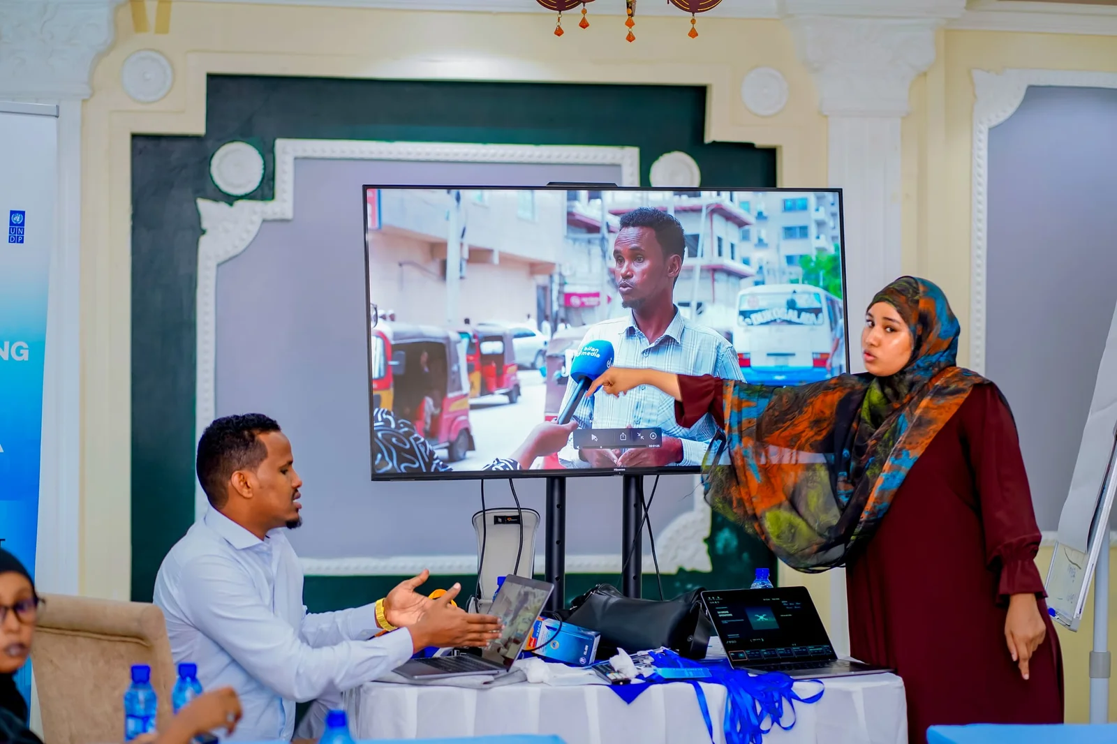 A participant presenting recorded interview footage for review during the audiovisual production training.
