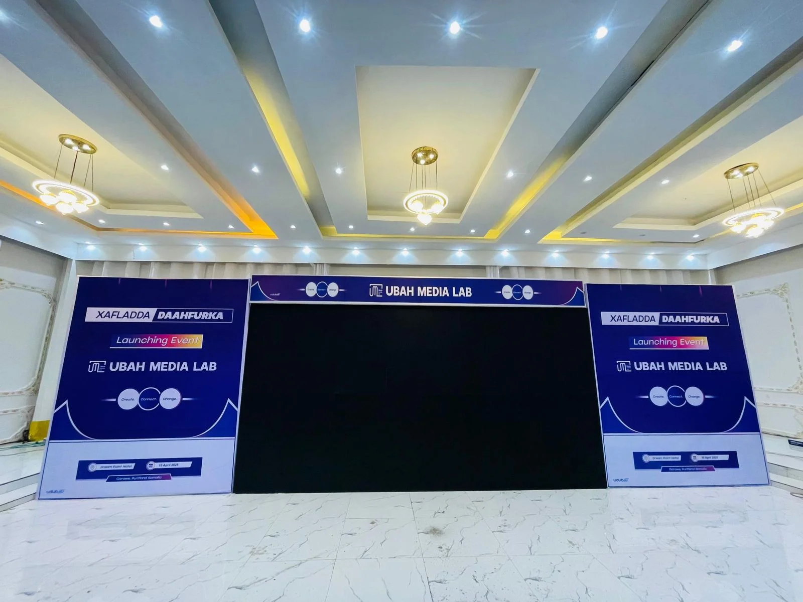 Printed purple event banners and a stage screen surround for Ubah Media Lab in Garowe.
