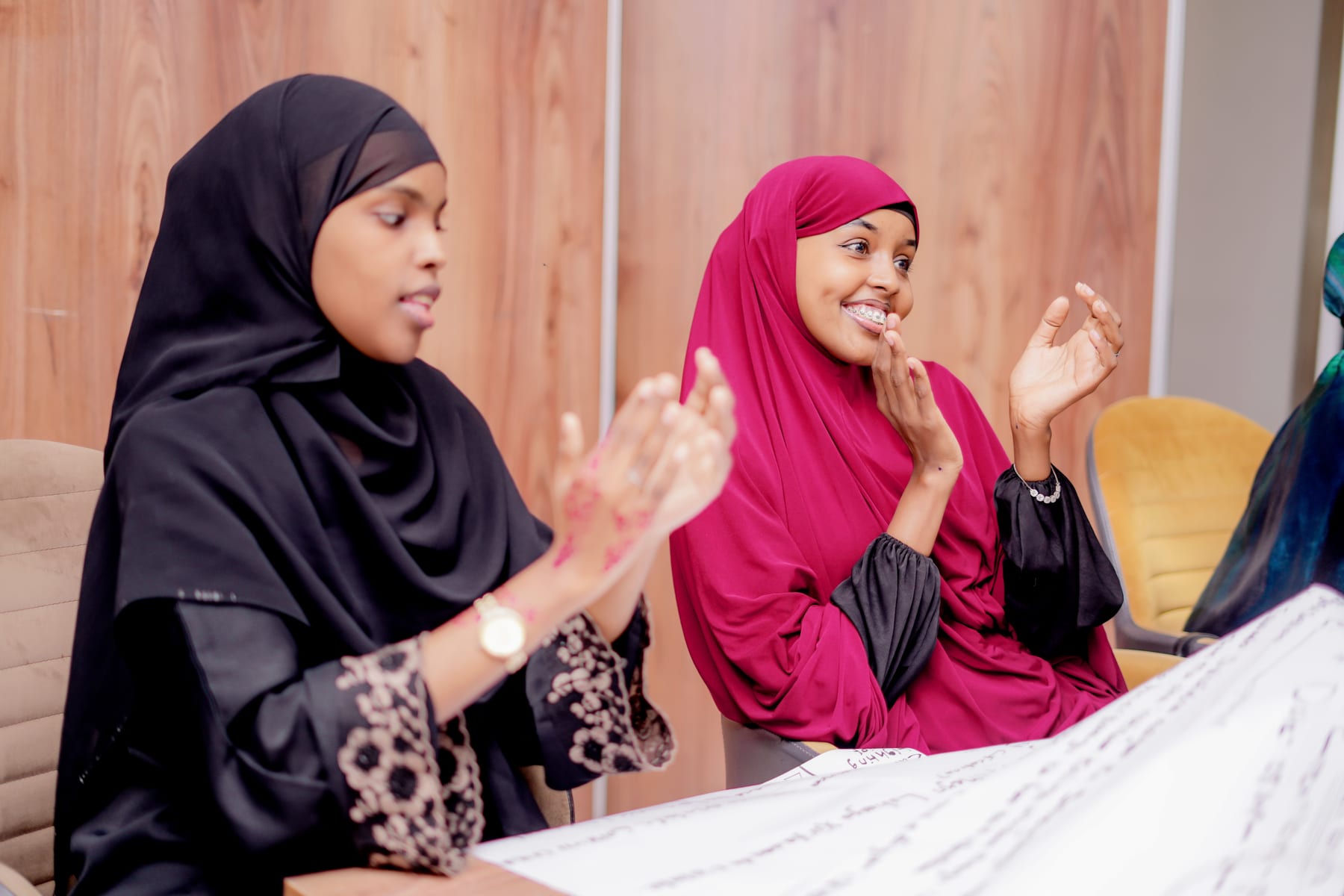 Participants celebrating their group work during the Training of Trainers for Bilan Media